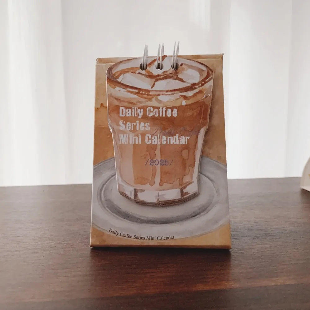 Mini 2025 desk calendar showing four design options including coffee time and motivational phrases