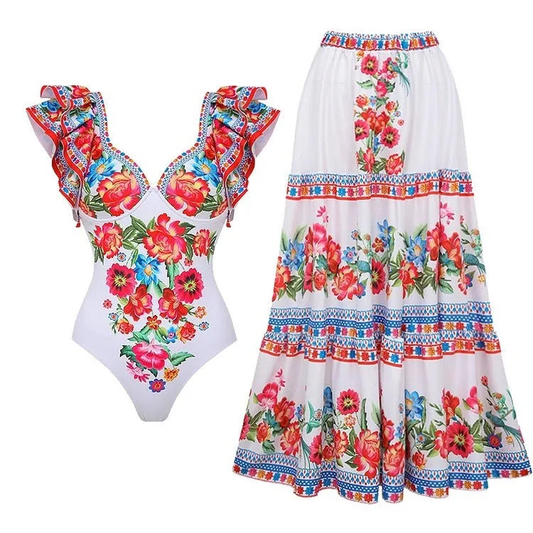 Women's printed one-piece swimsuit with skirt in blue, shown on a model.