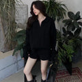 Women's creamy-white cable knit jumper and shorts set with elastic waistband.
