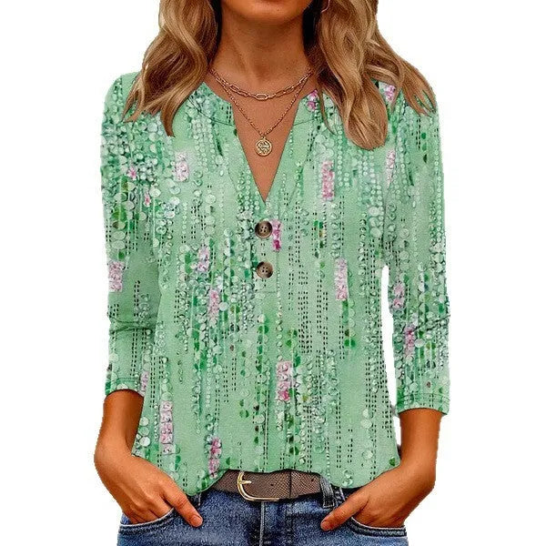 Women's loose-fit V-neck t-shirt with a blue 3D geometric print pattern.