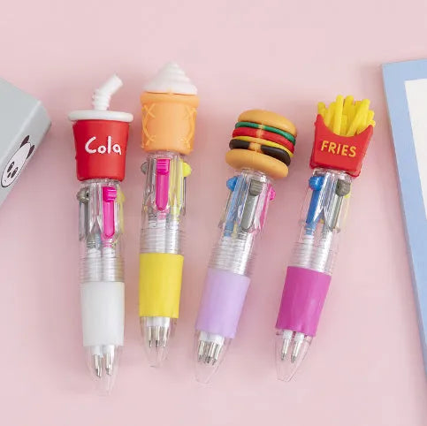 Cute cartoon four-colour press ballpoint pen with silicone grip and 0.7mm tip on a notepad.