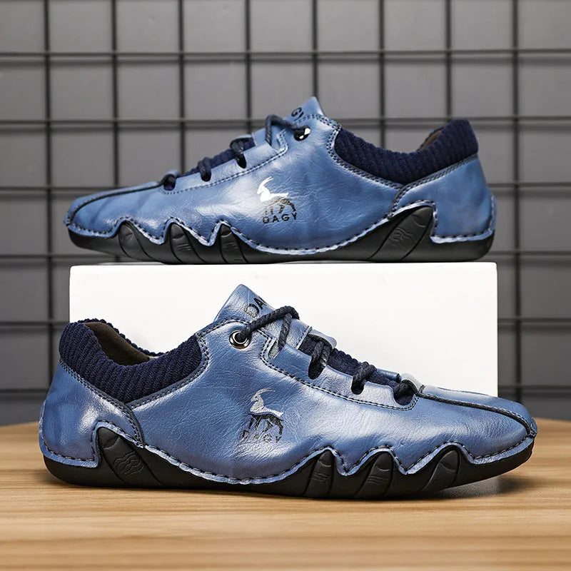 Men's solid colour lace-up casual sneakers with car stitching, blue upper, side view