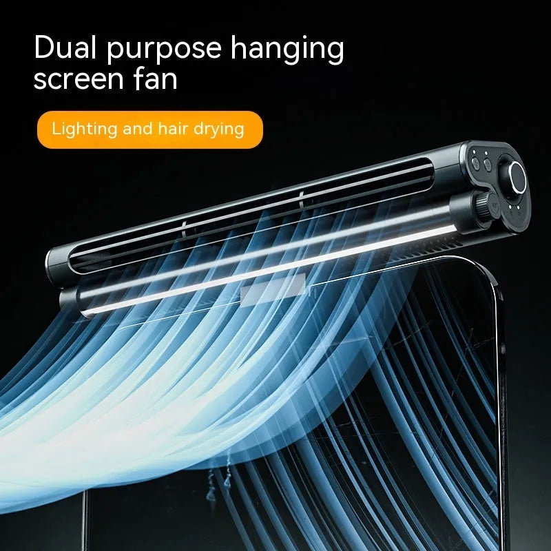Black bladeless USB fan with light clipped to top of a laptop screen.