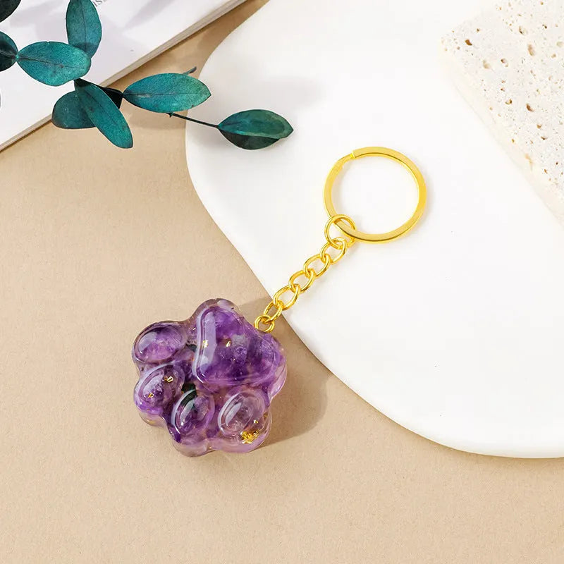 Small natural crystal cat's paw claw charm on a metal loop keychain