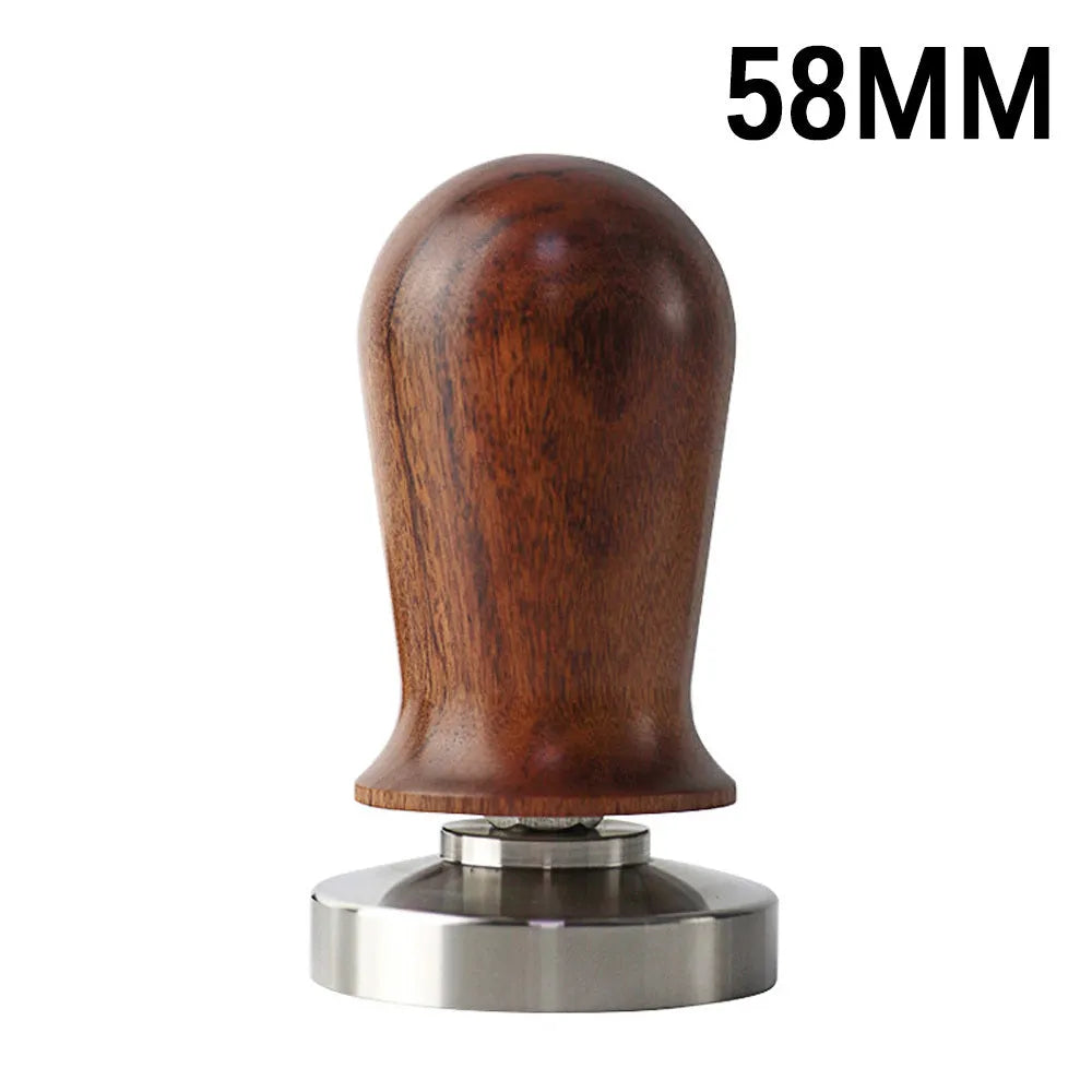 Black silicone pad coffee tamper with stainless steel base next to a red version on a counter.