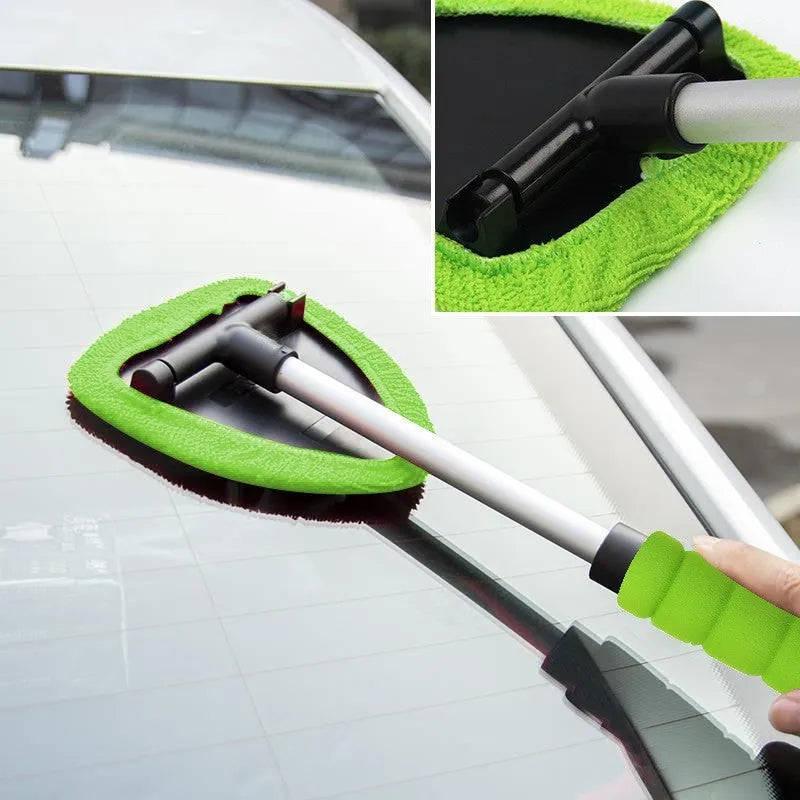 A plastic car windscreen cleaning brush with a long handle, shown in red, green, and blue colour options.