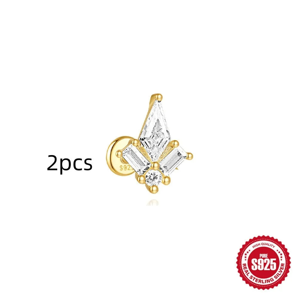 Geometric kite-shaped sterling silver stud earrings with rhinestones and a gold chain tassel.