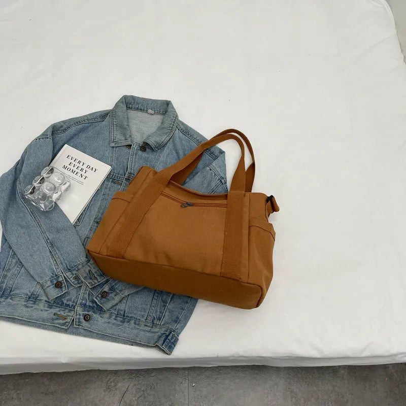 Women's polyester canvas shoulder bag with sandwich pocket in black, white, brown, or green