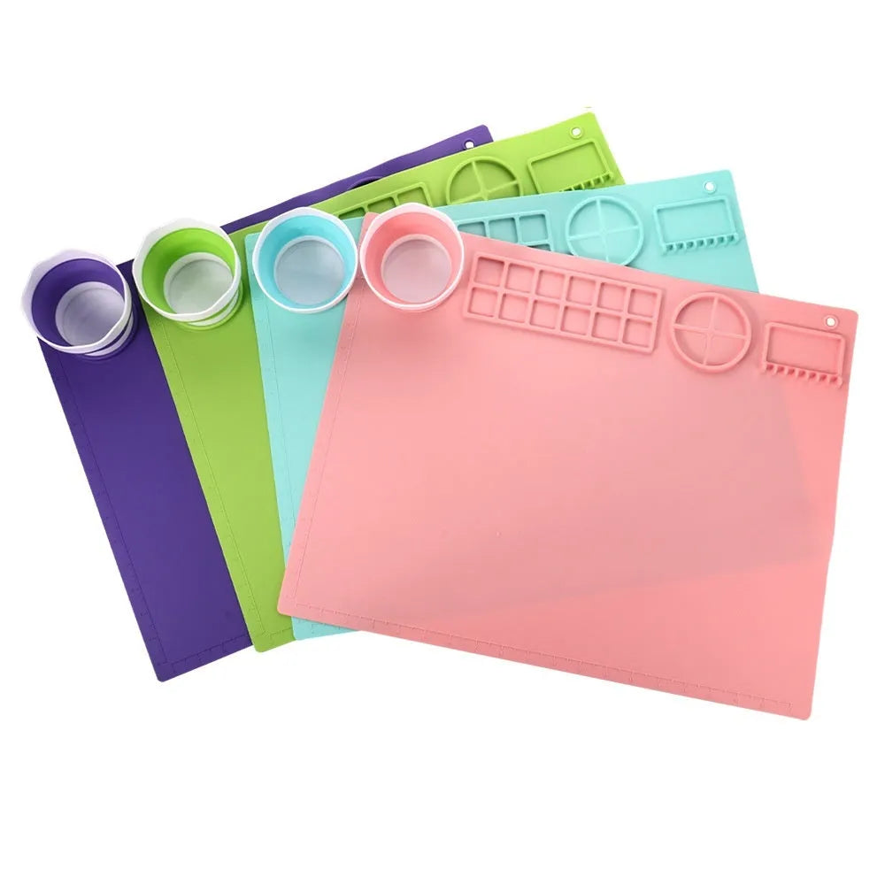Light blue silicone painting mat with two built-in mixing bowls for graffiti and watercolour art.