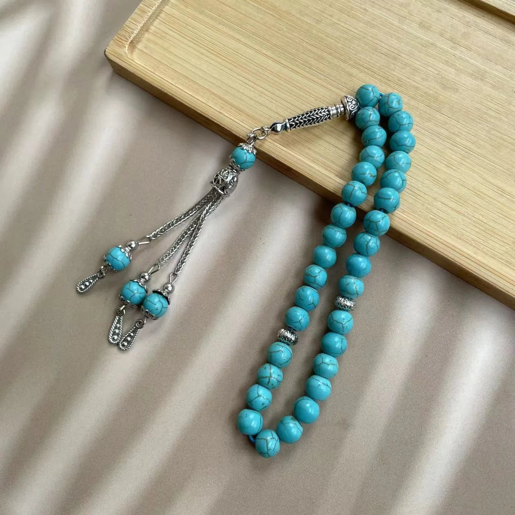 Handmade sky blue stone Muslim prayer bracelet with 8mm beads on a wrist.