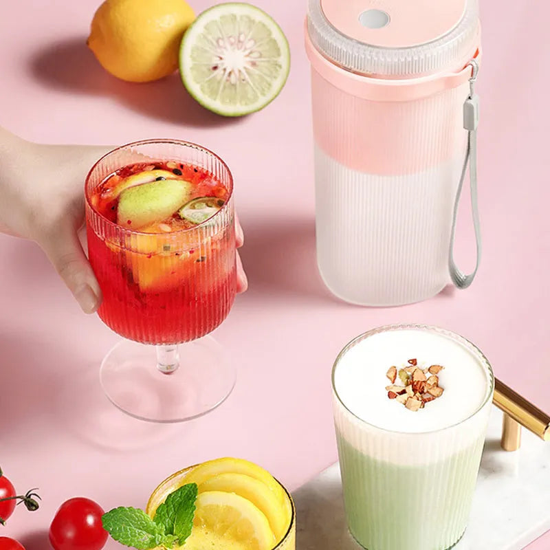 Portable electric blender cup in blue, green, or pink with USB charging cable.