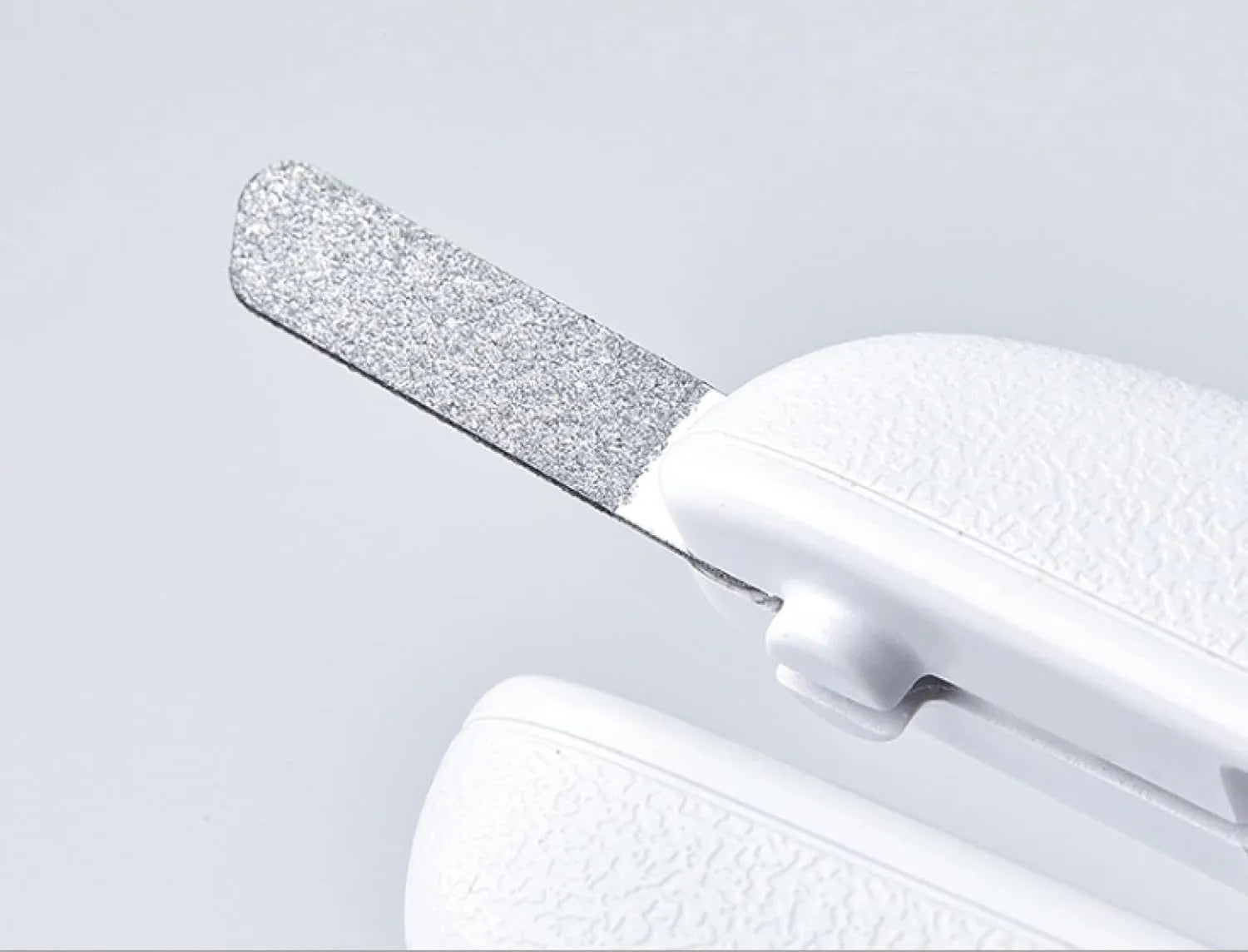 White LED pet nail clipper with a triangular blade, anti-splash guard, and leatherette handle.