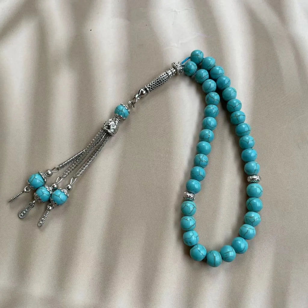 Handmade sky blue stone Muslim prayer bracelet with 8mm beads on a wrist.
