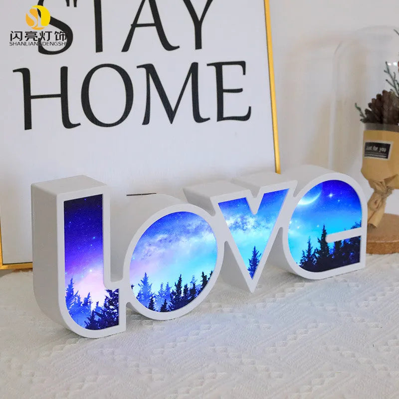 LED decorative light with rainbow-coloured LOVE word on plastic shade