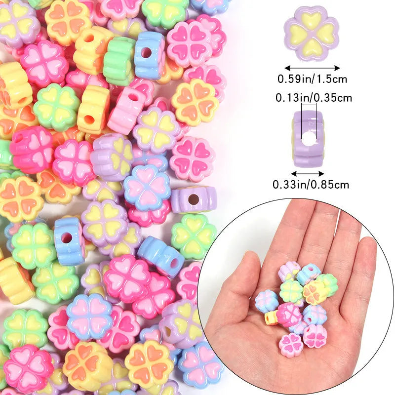 Assortment of frosted acrylic four-leaf clover shaped beads in rose red, pink, yellow, green, blue, and purple colours.
