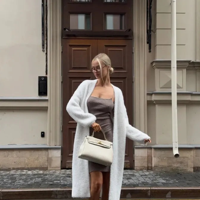 White women's longline cardigan sweater with loose fit and long sleeves.