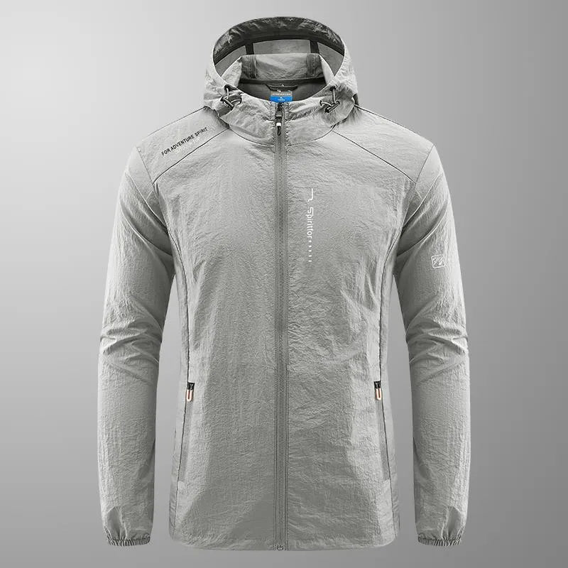 Man wearing a light grey loose-fitting hooded nylon summer jacket for sun protection.