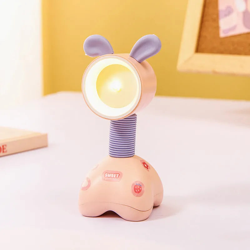 DIY cartoon animal small night lamp with magnetic base in assorted colours on a desk.