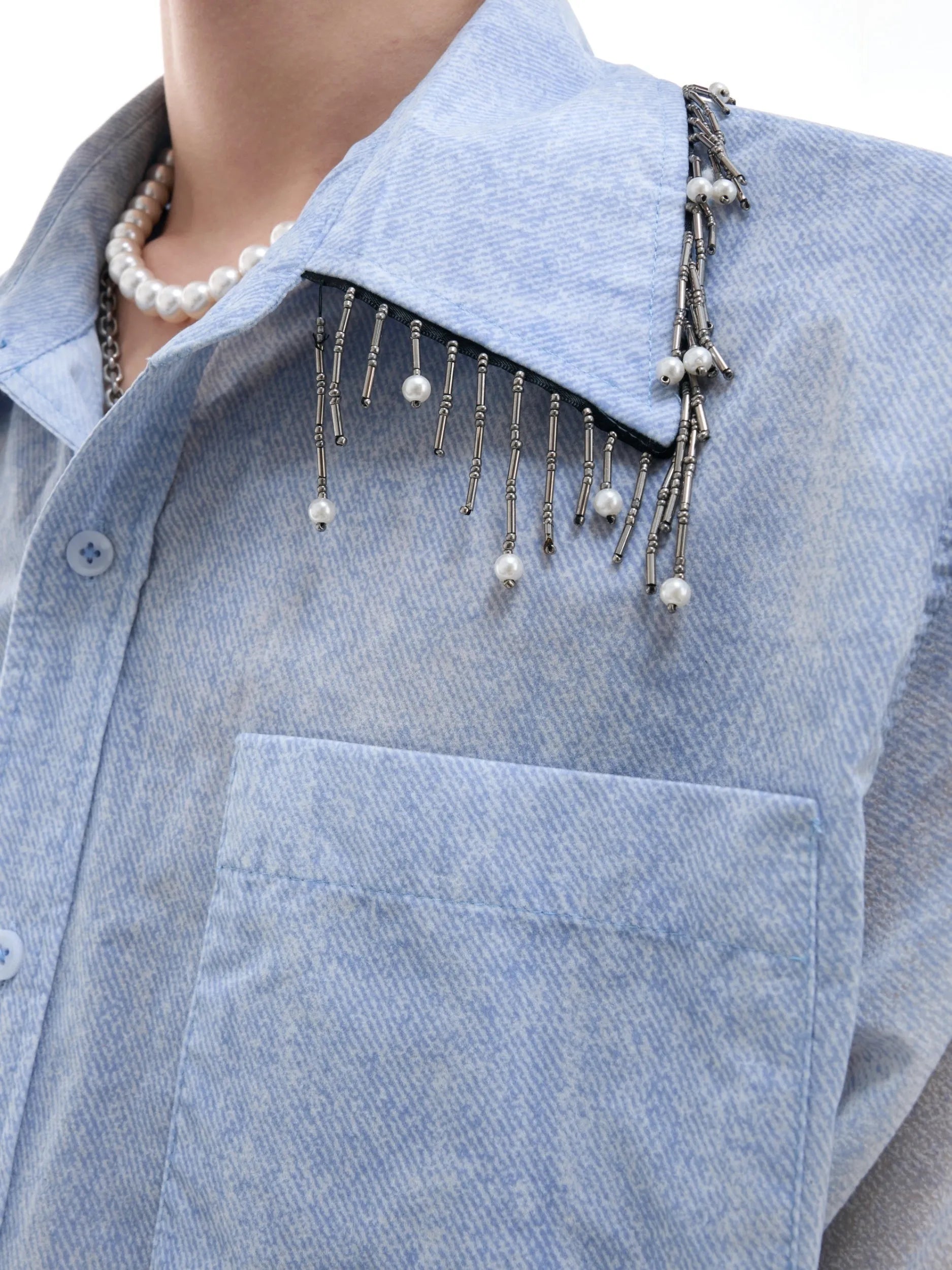A loose-fit blue men's short sleeve shirt with a white gradient fade.