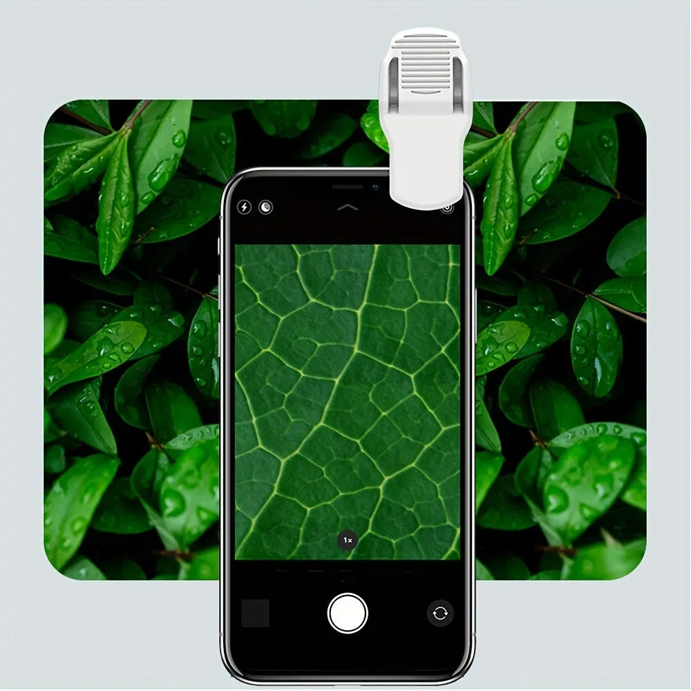 Mini 60x magnification smartphone microscope with LED light and detachable clip on a mobile phone