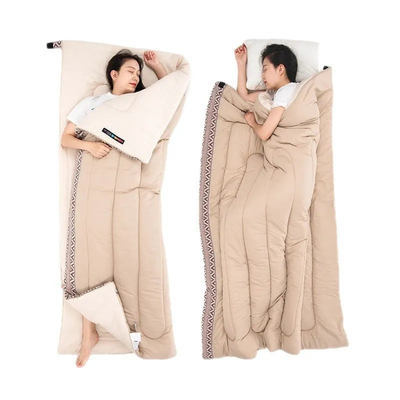 Four seasons camping sleeping bag in one of three colours with its storage bag, shown laid out.