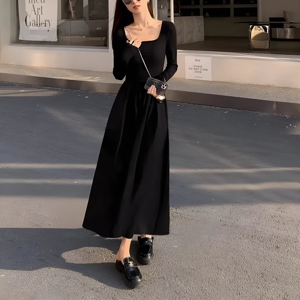 Women's black square collar knitted A-line dress with long sleeves on a hanger.