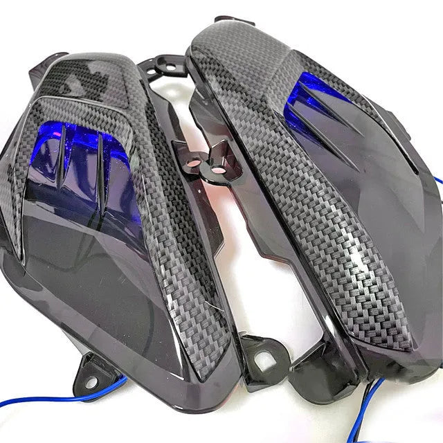 Pair of YAMAHA NMAX carbon fibre style LED side lamps, showing blue light option