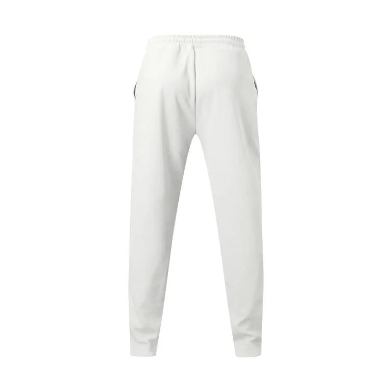 Men's loose straight drawstring trousers in waffle polyester fabric, shown in multiple colour options