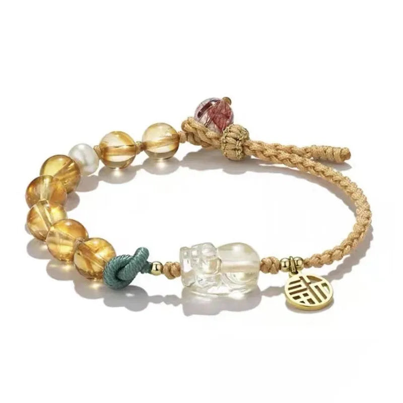 Hand-woven citrine crystal bracelet with zodiac animal design on wrist
