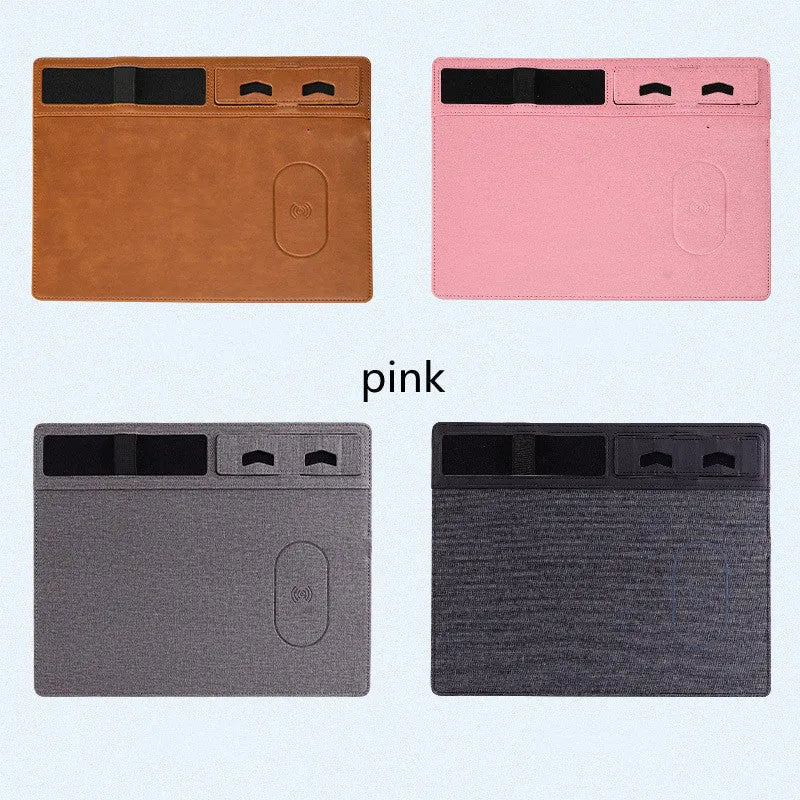 Pink wireless charging mouse pad with phone holder on a desk, showing USB cable and 320x260mm size.