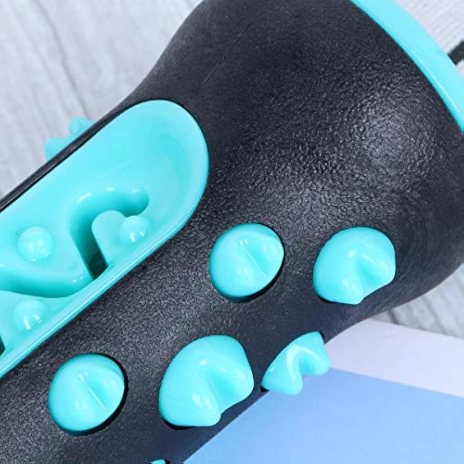 Natural rubber dog toothbrush chew toy in four colours: black/blue, blue, green, and yellow