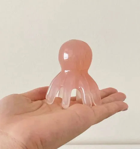 Small pink octopus-shaped massage comb for periocular meridian massage with natural resin material