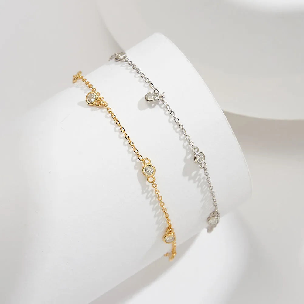 Women's sterling silver anklet with small geometric cubic zirconia pendant in gold or white gold finish.