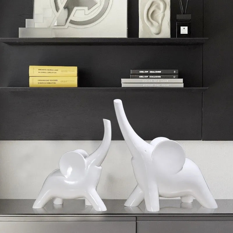 Modern minimalist solid resin elephant ornament in rose gold or white finish on a shelf.