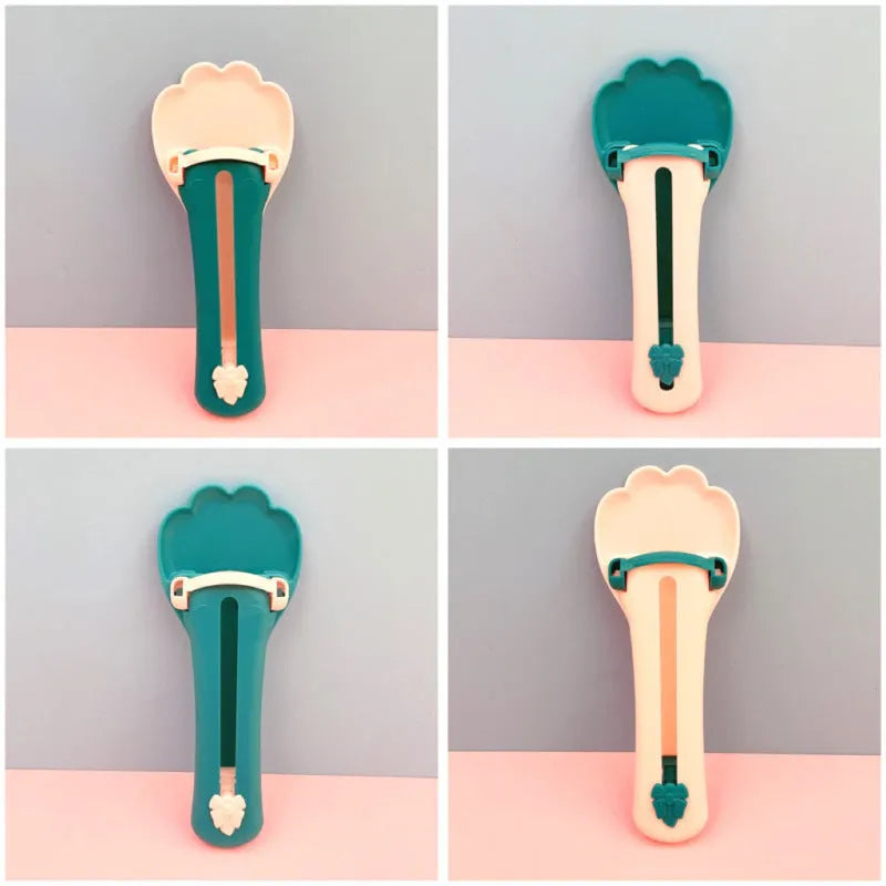 Green and pink pet food squeezer feeder with attached spoon for dispensing liquid and dry food