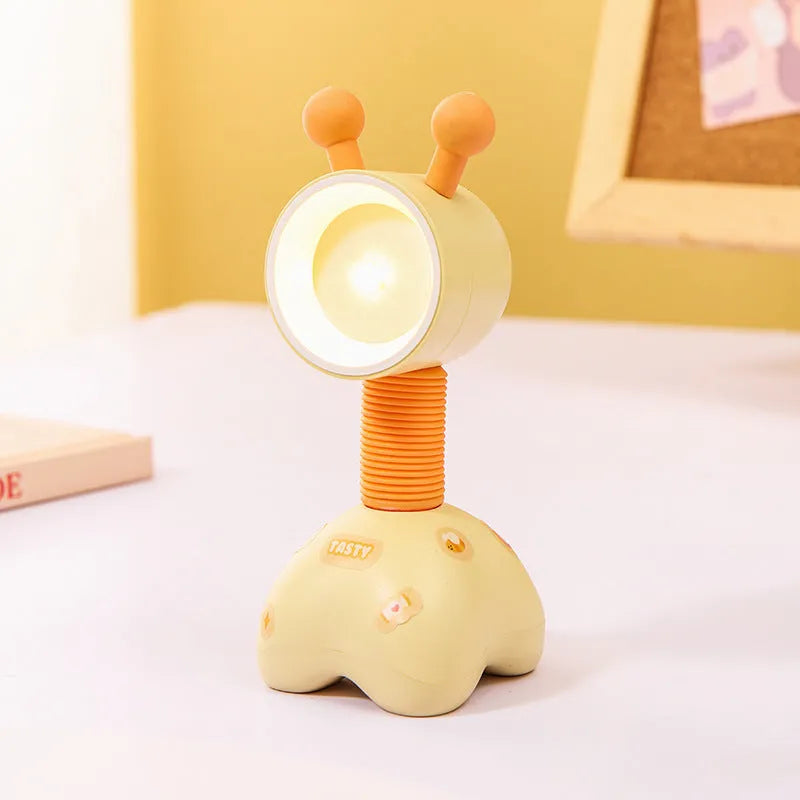 DIY cartoon animal small night lamp with magnetic base in assorted colours on a desk.
