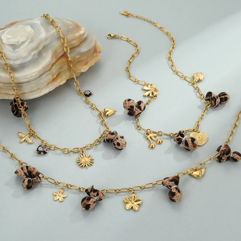 Gold plated stainless steel necklace with geometric leopard, love heart, and flowers pendant on a regular chain.
