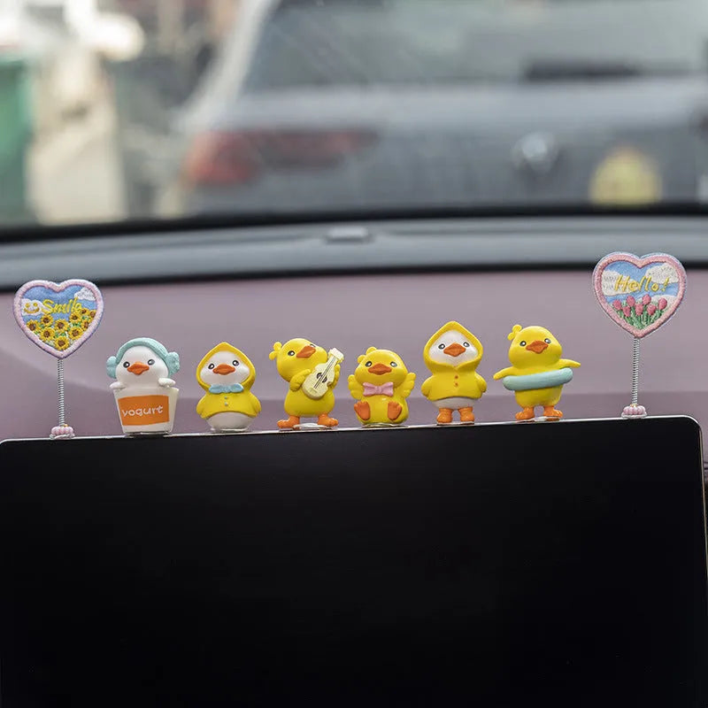 Set of six small PVC duckling ornaments and one larger Hello welcome sign for car interior decoration.