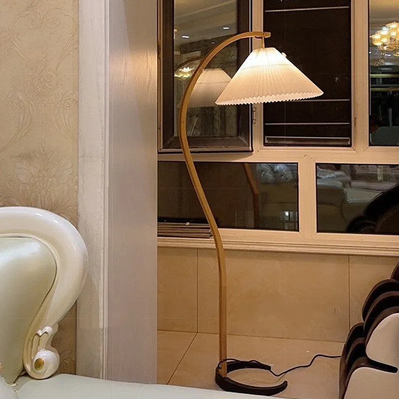 Vertical retro floor lamp with wood shade in three-colour variable light beside bed