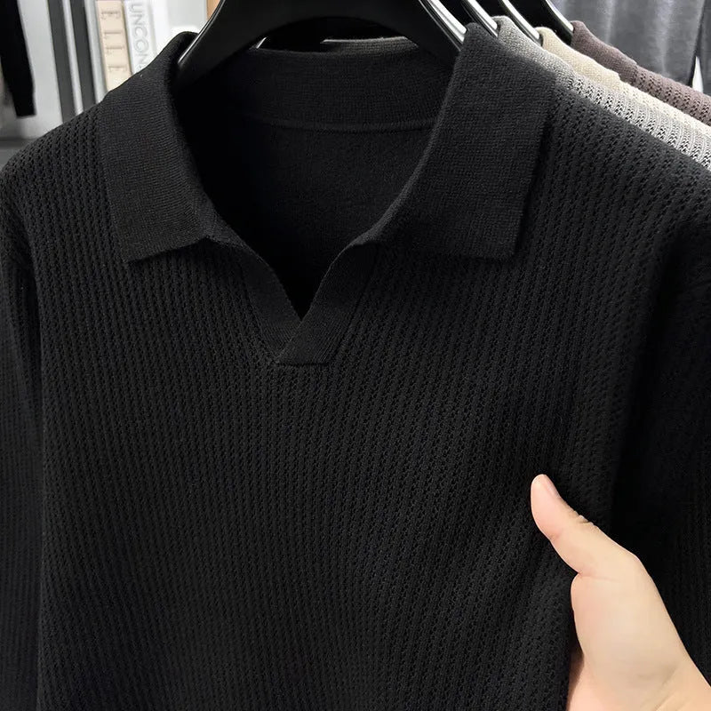 Men's loose green pullover sweater on a hanger, casual autumn wear