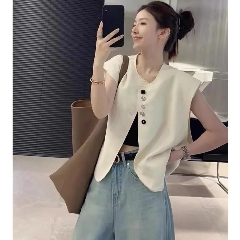 Women's loose-fit short polyester vest in milky white with pocket detail.