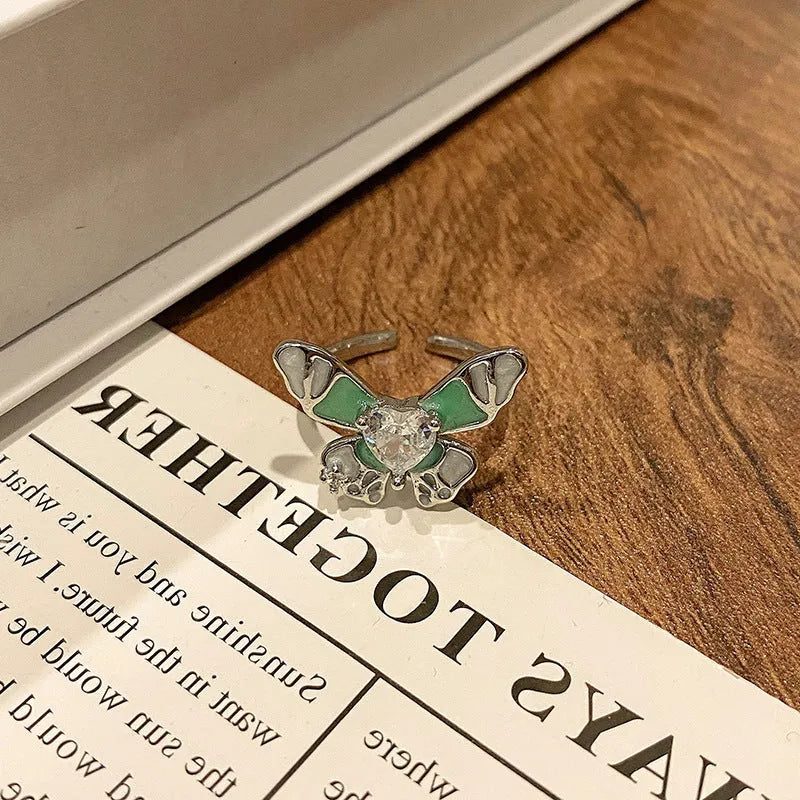 Copper butterfly women's ring with oil-drip finish showing open-loop design