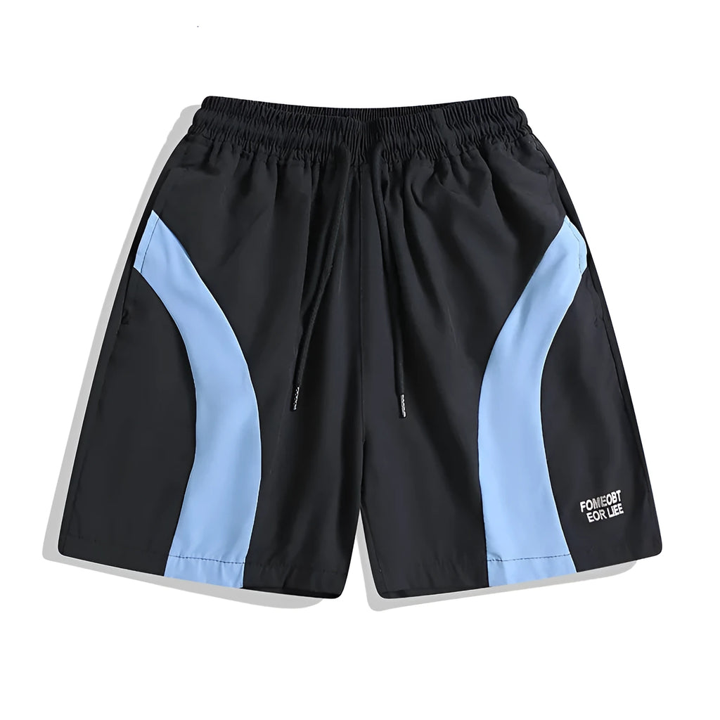 Man wearing loose-fit black quick-dry sports shorts with an elastic waistband.