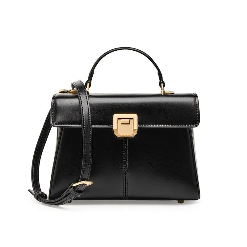 Women's black leather shoulder bag with vachette clasp, showing horizontal square shape and adjustable strap