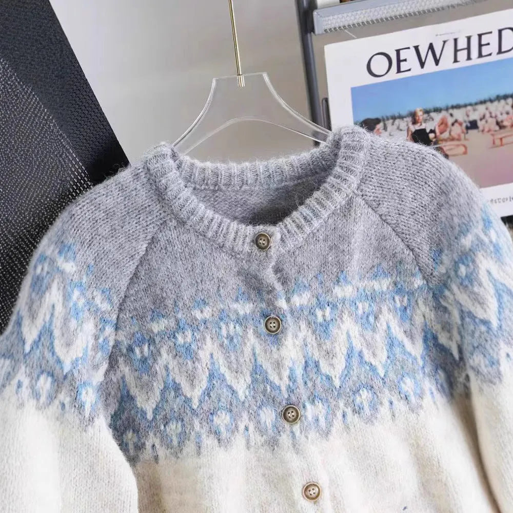 Women's beige jacquard knit sweater coat with contrast pattern, shown on a hanger.