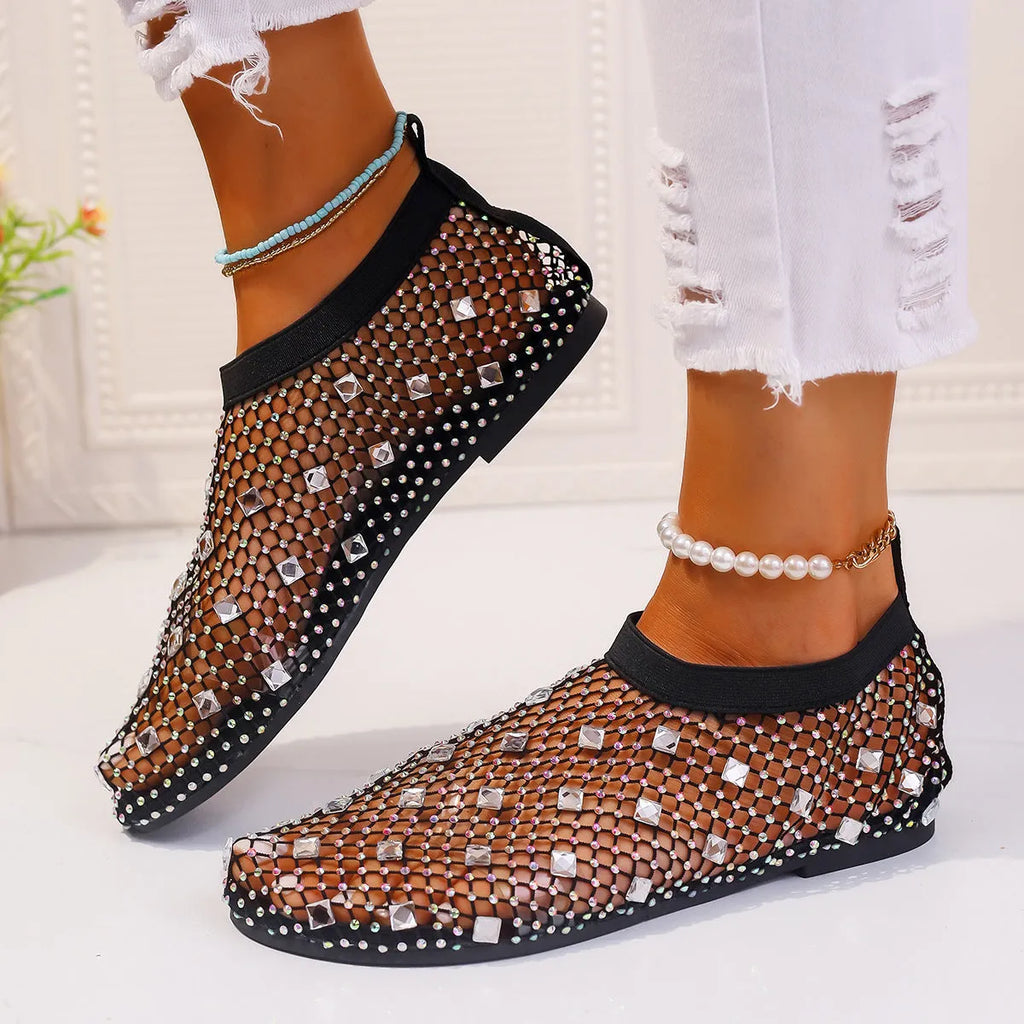Women's flat sandals with mesh upper, colourful rhinestone decoration, and a rubber sole.