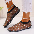 Women's flat sandals with mesh upper, colourful rhinestone decoration, and a rubber sole.