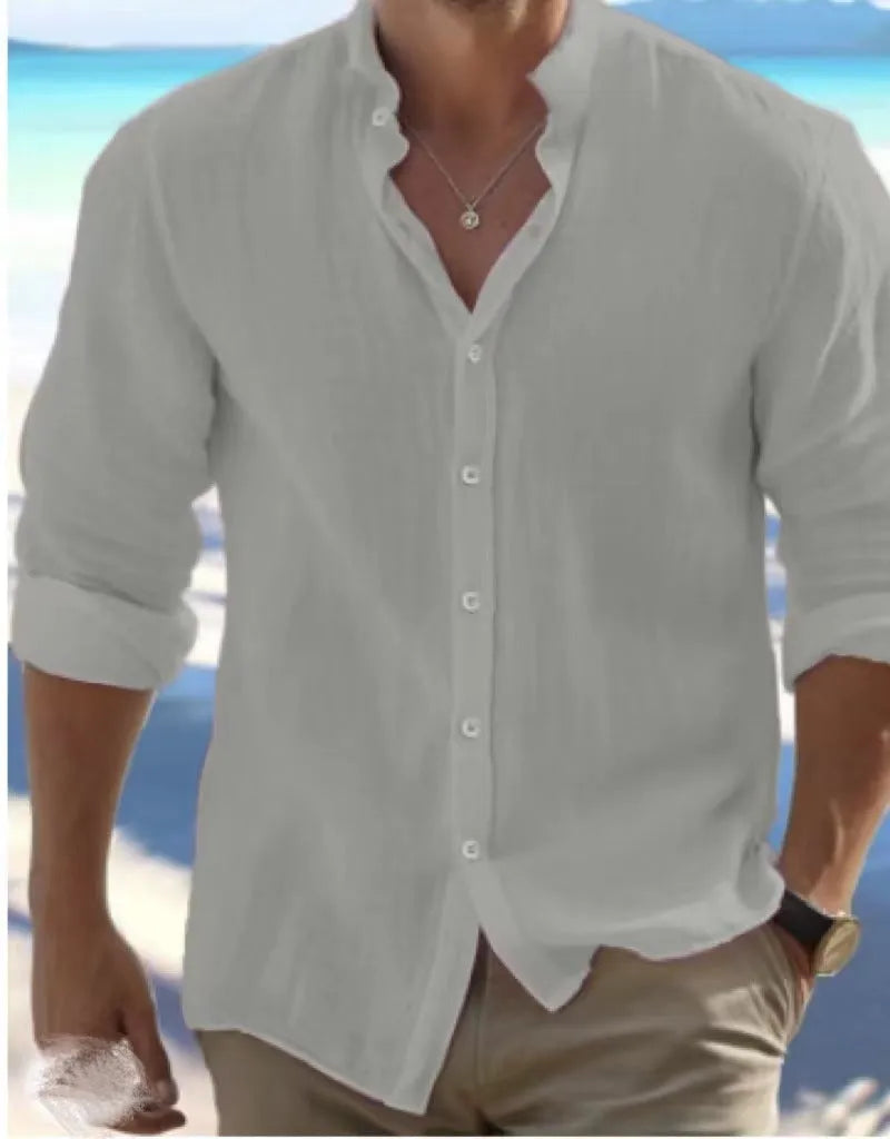 Men's white linen button-up summer beach shirt with collar on a hanger.