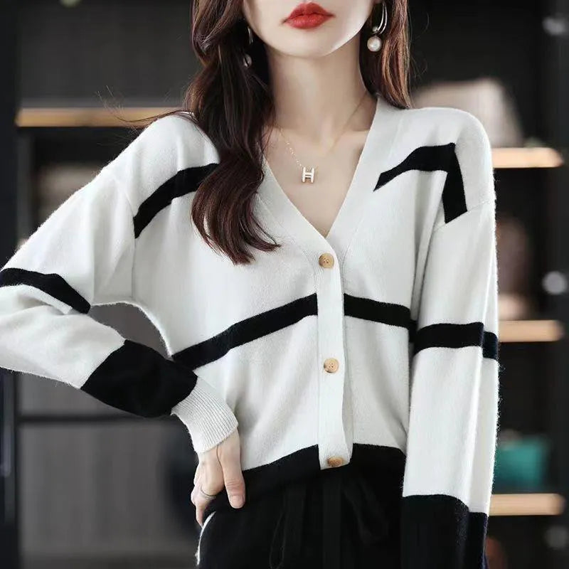 Women's striped V-neck knitted cardigan with 3D patterned sleeves and button front in a slim fit.