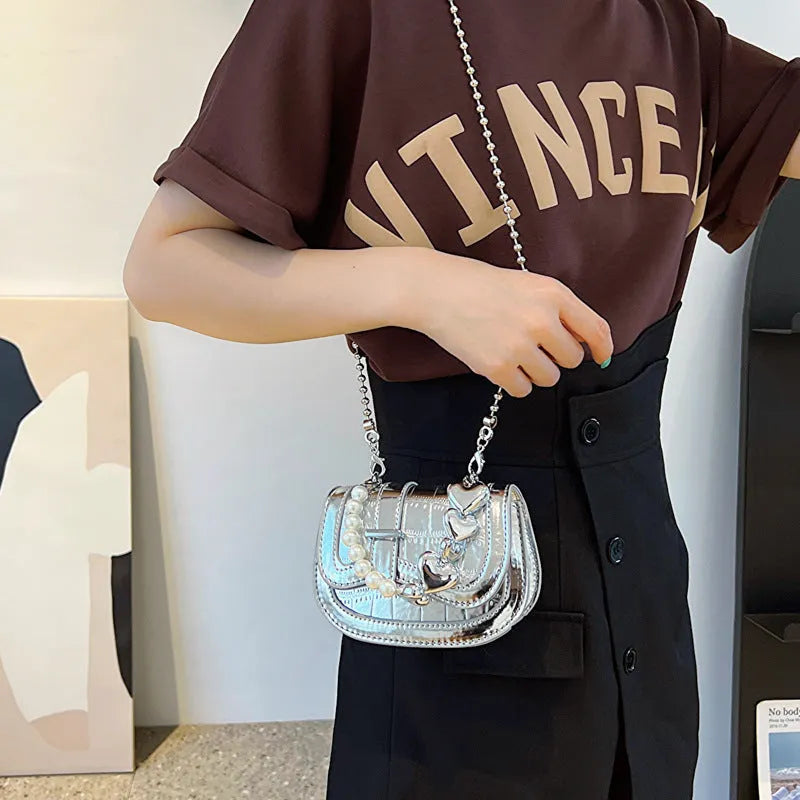 Silver laser pearl women's mini crossbody bag with a horizontal square shape and single shoulder strap.